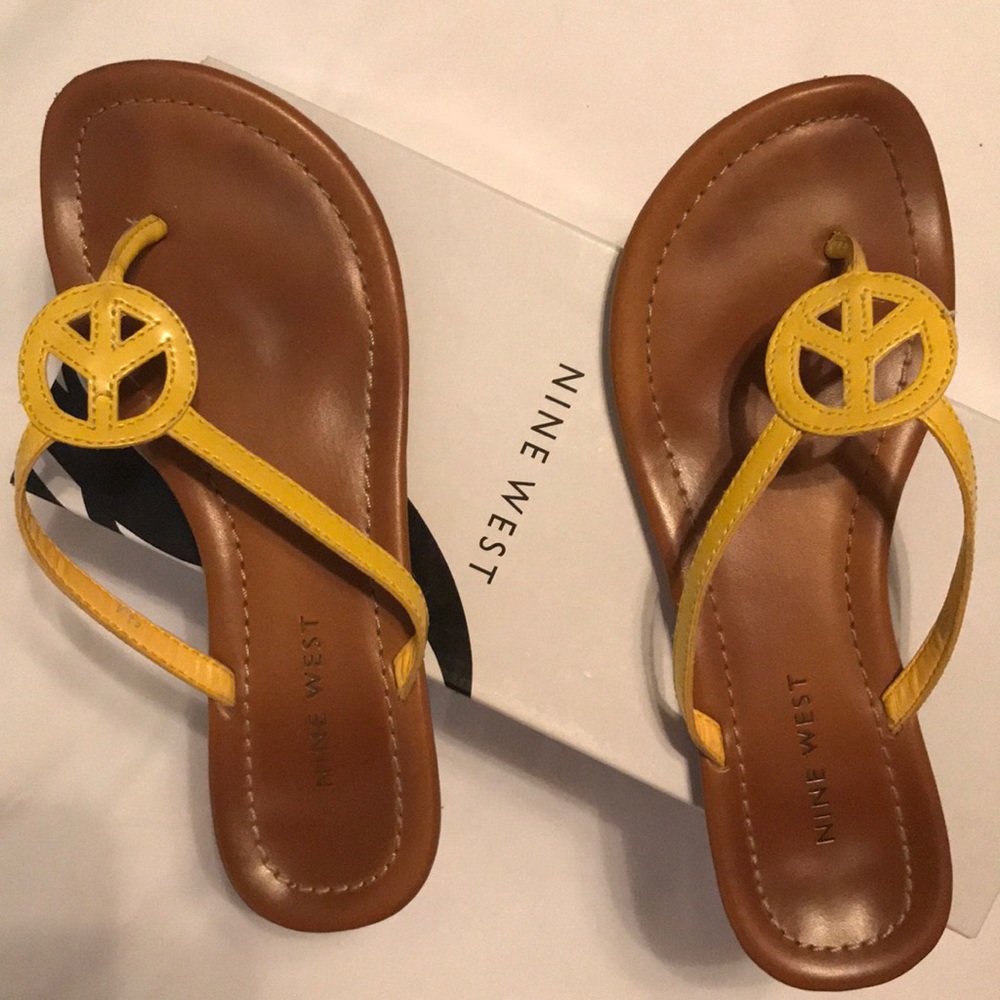 Nine West yellow peace sign flip flops.